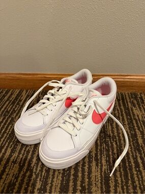 Nike White Low-Top Sneakers with Coral Pink Swoosh